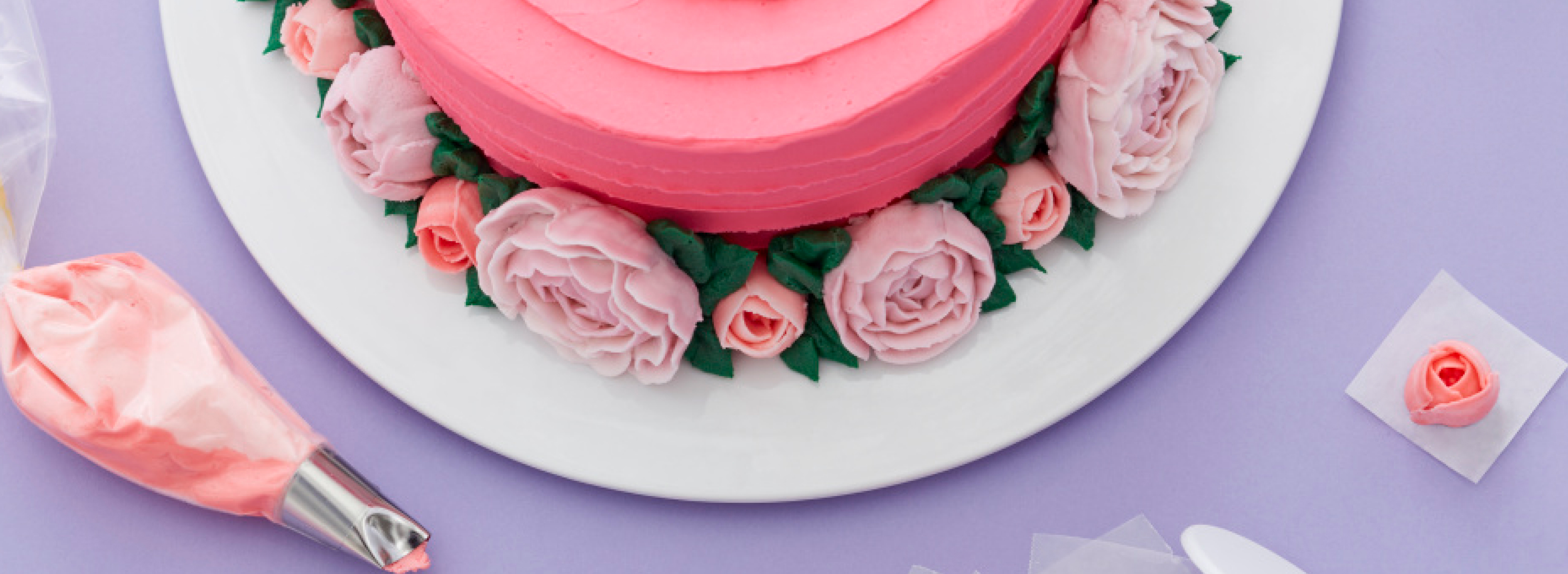 Pink cake with piped frosted roses